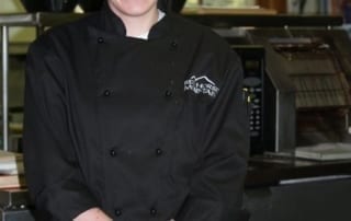 Lauren posing with plated desserts