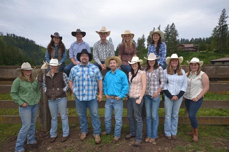 Trail Riders Group posed on fence