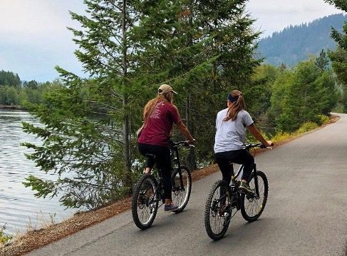 two cyclists on a bike trail