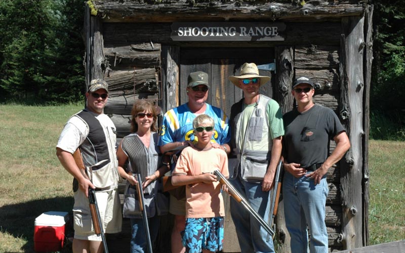 family posing at shooting range