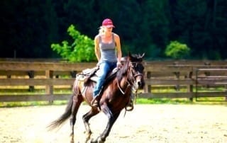 woman riding horseback on the ranch