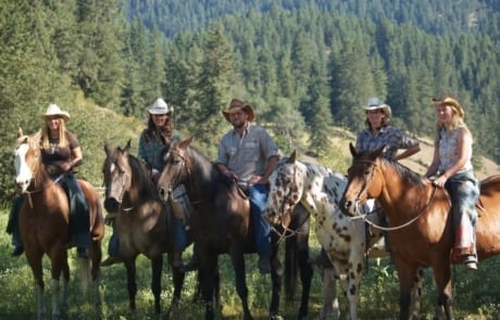 group of wranglers posing on horseback