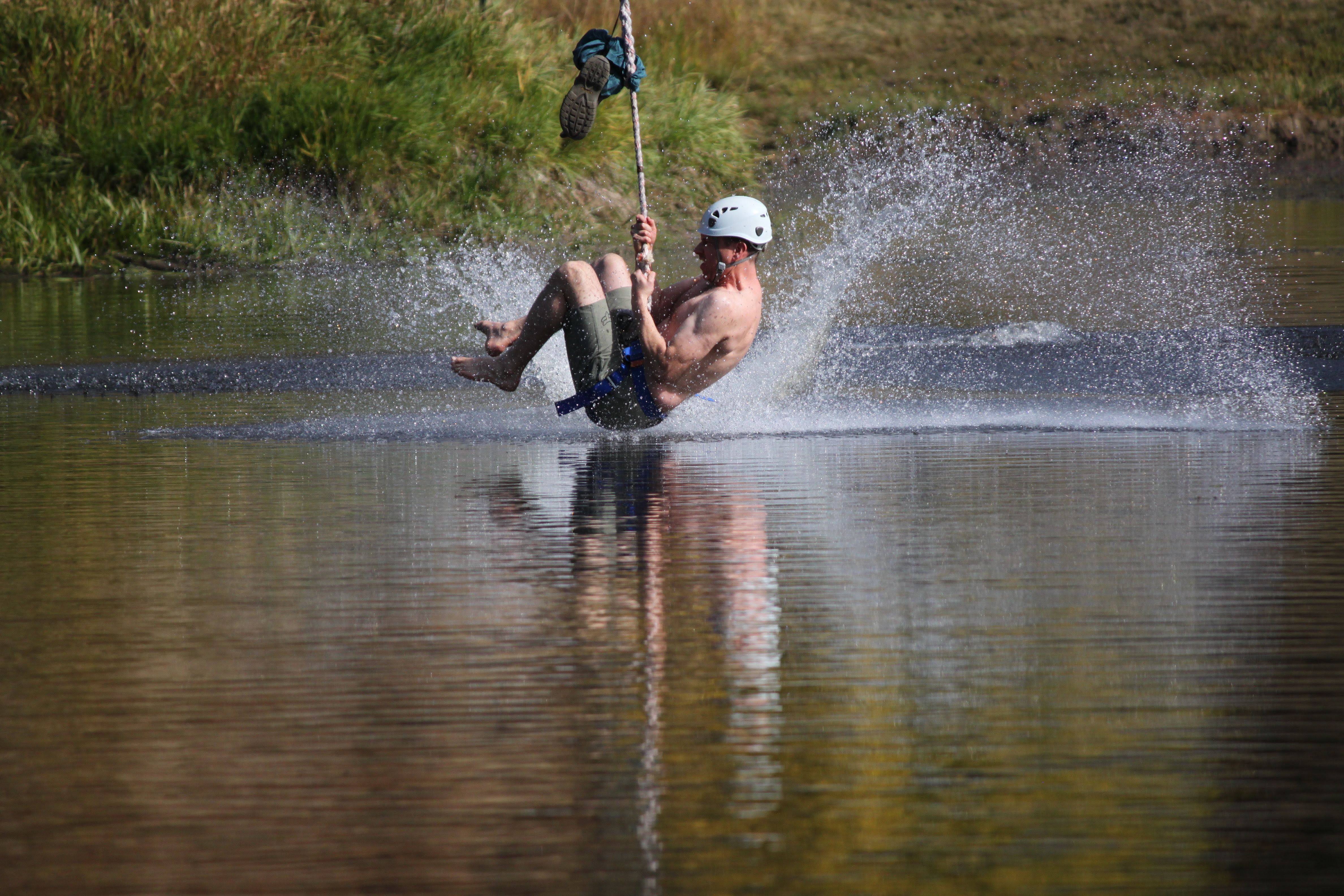 person on zipline landing in water