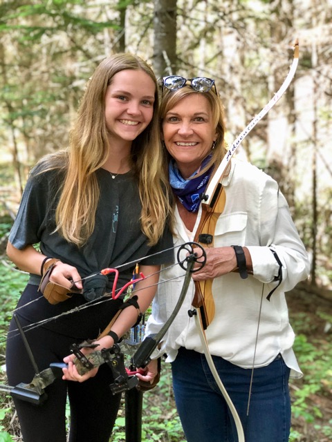 A mother-daughter couple getting ready to test their skills at the archery range.