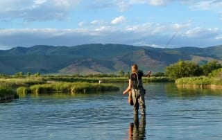 A solitary female angler tries her hand at fishing in Idaho on the Saint Joe River.