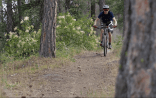 An avid mountain biker makes his way down a nearby trail.