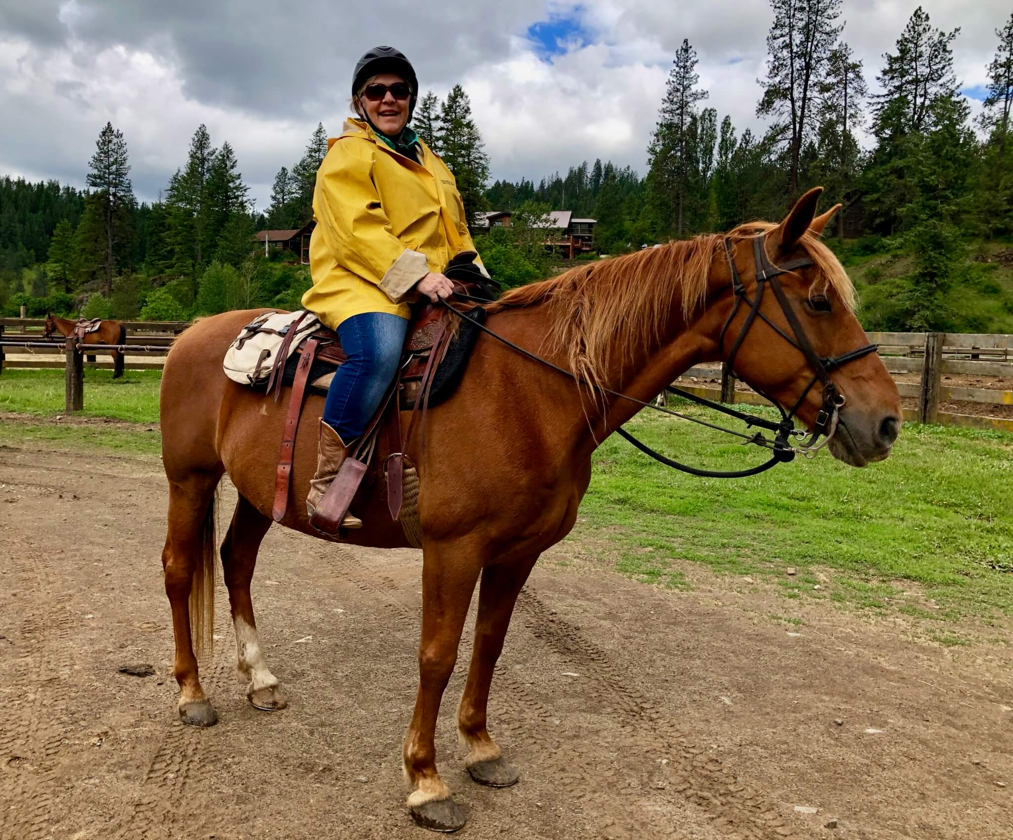 A seasoned wrangler smiles with glee while enjoying an adult getaway at Red Horse Mountain Ranch outside of Harrison, ID.