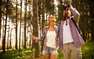 A couple uses binocular to catch a glimpse of some birds in Idaho.