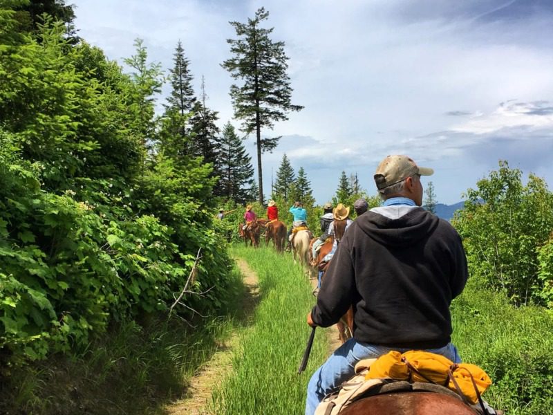 Guest Ranch Vacation: A line of horseback riders make their way along an alpine ridge near Red Horse Mountain Ranch in Idaho.
